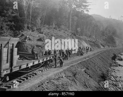 Industries of War - Lumbering - Track laying north of Yaquina, spikers following train ca. 1915-1920 Stock Photo