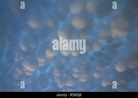Mammatus clouds fill the sky after a passing supercell thunderstorm. Stock Photo