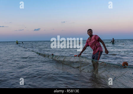 Fishermen haul out there nets in Mozambique. Stock Photo