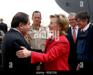 Upon her arrival in Baghdad, Iraq on April 25, 2009, U.S. Secretary of State Hillary Rodham Clinton is greeted by newly arrived U.S. Ambassador to Iraq Christopher R. Hill, Chairman of the Joint Chiefs of Staff Admiral Michael Mullen, and Iraq’s Minister of Foreign Affairs Hoshyar Zebari. Deputy Secretary James Steinberg (to the far right) looks on. Stock Photo