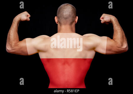 The back of a young athletic man wearing a T-shirt with the national flag of Poland on a black isolated background. The concept of national pride and  Stock Photo