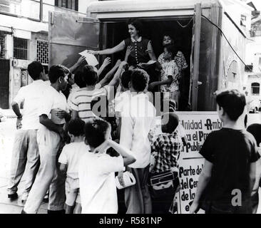 A U.S.I.S. employee distributes mimeographed leaflets describing plans for bookmobile.An estimated 5,000 leaflets were distributed in Santa Ana Plaza. Stock Photo