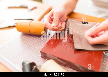 Working process of the leather wallet in the leather workshop Stock Photo