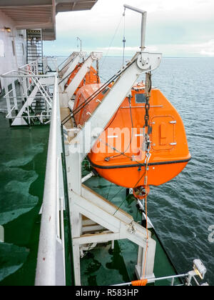 A lifeboat in case of an accident in the port or on a ship. The Stock Photo