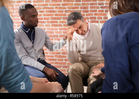 African Man Consoling His Friend Stock Photo