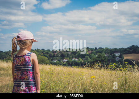 Cute young Caucasian girl looking at the rural countryside in southern England Stock Photo