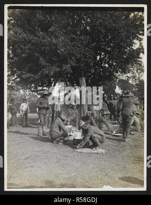 Gurkhas cooking & preparing food [St Floris, France]. Men of the 9th Gurkhas cooking over open fires, 23rd July 1915. Record of the Indian Army in Europe during the First World War. 20th century, 23rd July 1915. Gelatin silver prints. Source: Photo 24/(63). Author: Girdwood, H. D. Stock Photo