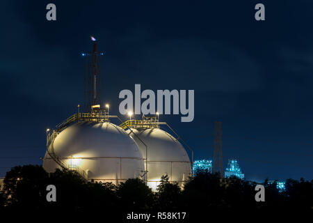 Landscape of oil refinery industry with oil storage tank in night. Stock Photo