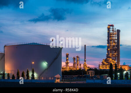 Landscape of oil refinery industry with oil storage tank in night. Stock Photo