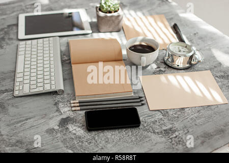 Office desk table with computer, supplies and phone Stock Photo