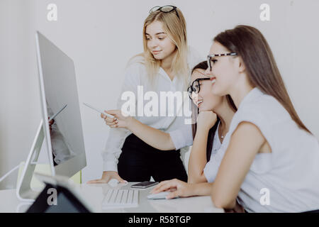 Diverse young and senior female colleagues excited by online win or business achievement, multiracial happy businesswomen celebrating victory looking  Stock Photo