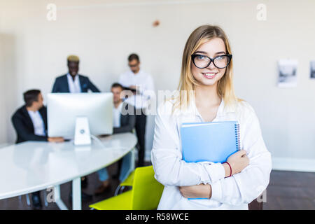 Successful young black business woman standing in front of multi ethnic group of people Stock Photo