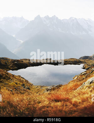 Colourful sunset on Chesery lake Lac De Cheserys in France Alps. Monte Bianco mountain range on background. Vallon de Berard Nature Preserve, Chamonix Stock Photo