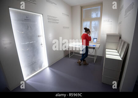 30 November 2018, Baden-Wuerttemberg, Stuttgart: A young woman stands during a press appointment in the permanent exhibition of the memorial place 'Hotel Silber'. After an almost demolition, long planning and several postponements, the former headquarters of the Secret State Police (Gestapo) is opened on 04 December as a 'place of historical-political learning'. Photo: Marijan Murat/dpa Stock Photo