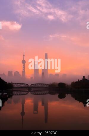 Shanghai, China, 30 November 2018. Lujiazui, opposite the Huangpu River on the Bund, is graceful in the fog, and the sunshine gradually rises to make Lujiazui more beautiful and spectacular. Credit: Costfoto/Alamy Live News
