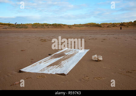 Crosby, Merseyside. 30th Nov 2018. UK Weather. UK Storm Diana beach debris on the shoreline. The inevitable assortment of plastic debris washed up by the tide and deposited on the famous beach near Liverpool. Crosby beach is known as a Another Place and is the site of an iron men installation of 100 figures by the artist Antony Gormley. Credit: MediaWorldImages/AlamyLiveNews. Stock Photo