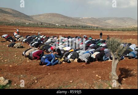 Ramallah, West Bank, Palestinian Territory. 30th Nov, 2018. Palestinian protesters attend Friday prayers during clashes Israeli forces against Israeli land seizures for Jewish settlements, in the village of al-Mughayyir, near the West Bank city of Ramallah, on November 30, 2018 Credit: Ahmad Arouri/APA Images/ZUMA Wire/Alamy Live News Stock Photo