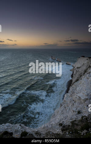 The Needles, Isle of Wight. 30th Nov 2018. UK Weather: A cold and windy November evening at sunset at the Needles lighthouse on the Isle of Wight after the recent stormy weather. Rough seas prevail and the wind beginning to pick up again bringing large waves with white crests to the surf and breakers on the beach at the bottom of the chalk cliffs. Credit: Steve Hawkins Photography/Alamy Live News Stock Photo