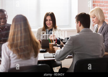 Female Manager With Her Colleague In Office Stock Photo