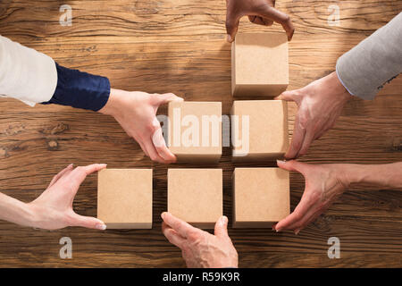 Businesspeople Arranging The Wooden Block Stock Photo