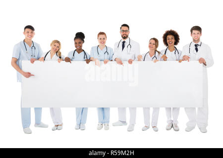 Group Of Medical Team Holding Blank Billboard Stock Photo