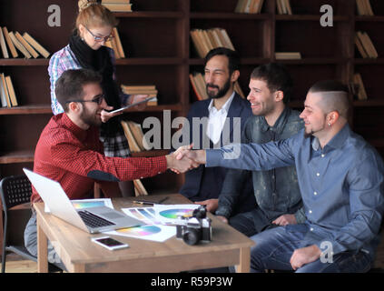 handshake of two designers at a working meeting in the office Stock Photo