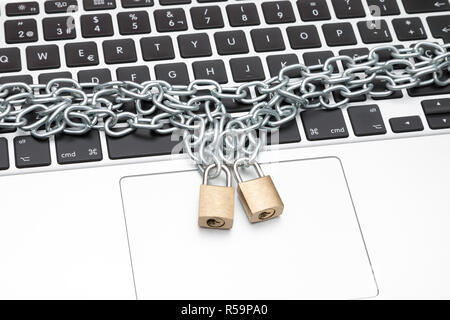 Computer security Secure computer with padlocks and chains. Armored laptop Stock Photo