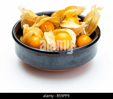 Bowl with flowers and fruits of Fisalis (Physalis peruviana) isolated on white background. Stock Photo