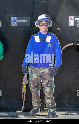 Blue-jerseyed Flight Deck person (operate tow tractors and aircraft elevators) USS Midway Museum, San Diego Bay, California, United States. Stock Photo