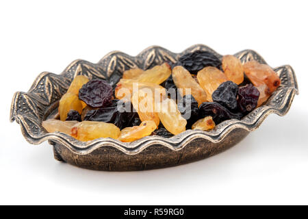 Black and yellow raisins on a white background Stock Photo