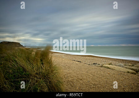 A stormy day with rough sea and fast moving clouds captured with a long exposure on Bournemouth's coastline. Stock Photo