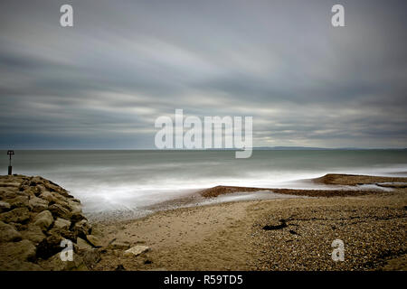 A stormy day with rough sea and fast moving clouds captured with a long exposure on Bournemouth's coastline. Stock Photo