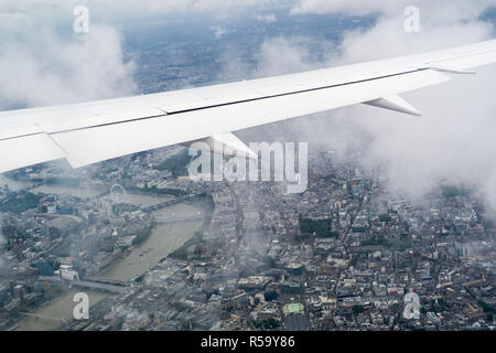 Airplane flying over London Stock Photo