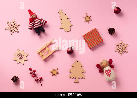Greeting card for New year party. Christmas gifts, decorative elements and ornaments on pink background. Top view. Winter holiday concept. Stock Photo