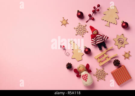 Greeting card for New year party. Christmas gifts, decorative elements and ornaments on pink background. Top view, copy space. Winter holiday concept. Stock Photo