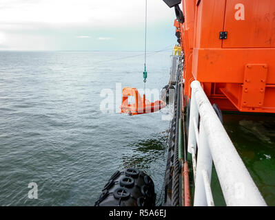 A lifeboat in case of an accident in the port or on a ship. The Stock Photo