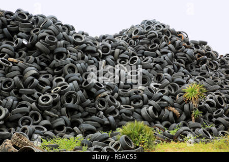 Old car tires lying on a pile for recycling Stock Photo