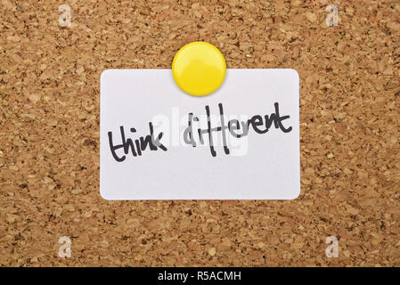 Text Think Different written on a pinned white sticker Stock Photo