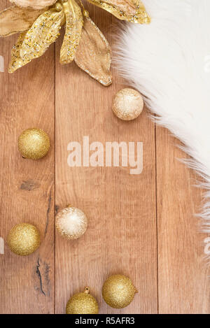Christmas background. Gold Christmas balls on a wooden background. Winter holidays concept. Top view with copy space, vertical image. Stock Photo