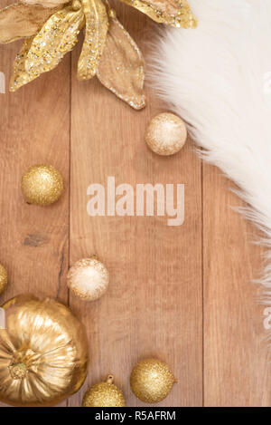 Christmas background. Gold Christmas balls on a wooden background. Winter holidays concept. Top view with copy space, vertical image. Stock Photo