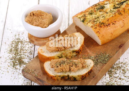 Norwegian cheese brunost on white wooden table Stock Photo