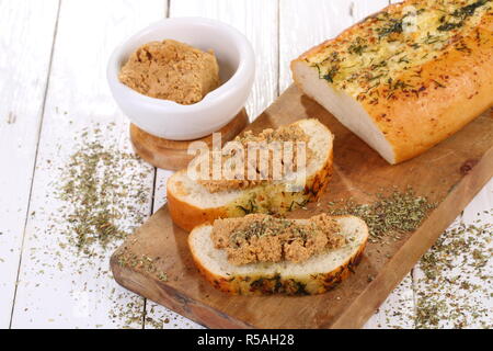 Norwegian cheese brunost on white wooden table Stock Photo