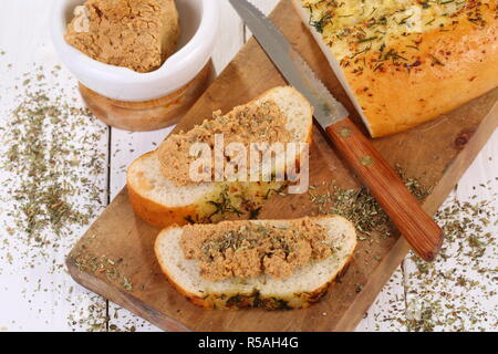 Norwegian cheese brunost on white wooden table Stock Photo