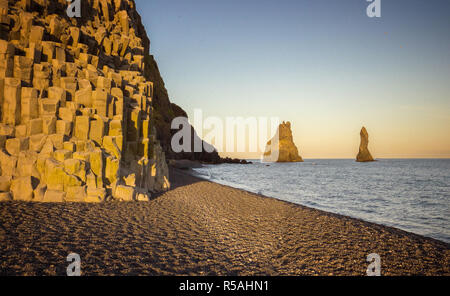 Beautiful sunset in black sand beach with huge cliffs, Iceland Stock Photo