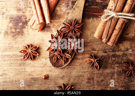 Anise star cinnamon sticks over wood background. Condiments on wooden background. Stock Photo