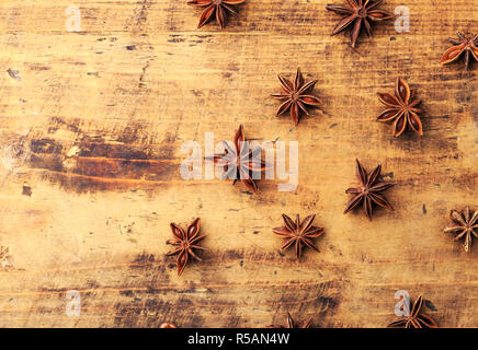 Anise stars on wood background with place for copyspace. Anason,anise star pattern. Stock Photo