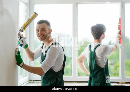 Workers are installing a window Stock Photo