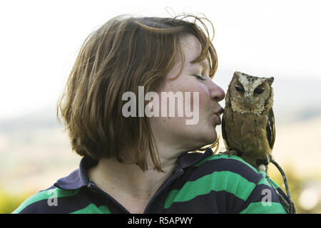 young woman with hindu collar owl on shoulder Stock Photo