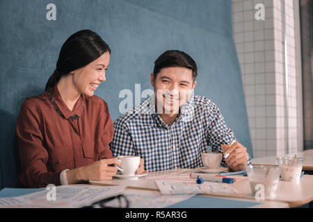 Top view of freelancers working together sitting in cafeteria Stock Photo