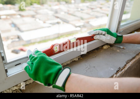 Hands holding a carpenter level Stock Photo